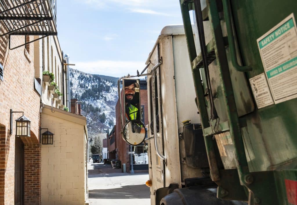 Waste Management driver Jorge Carballo pulls away after finishing at his stop behind Red Onion on Thursday, March 26, 2020. Carballo has worked for Waste Management for five years and is considered an essential employee. 