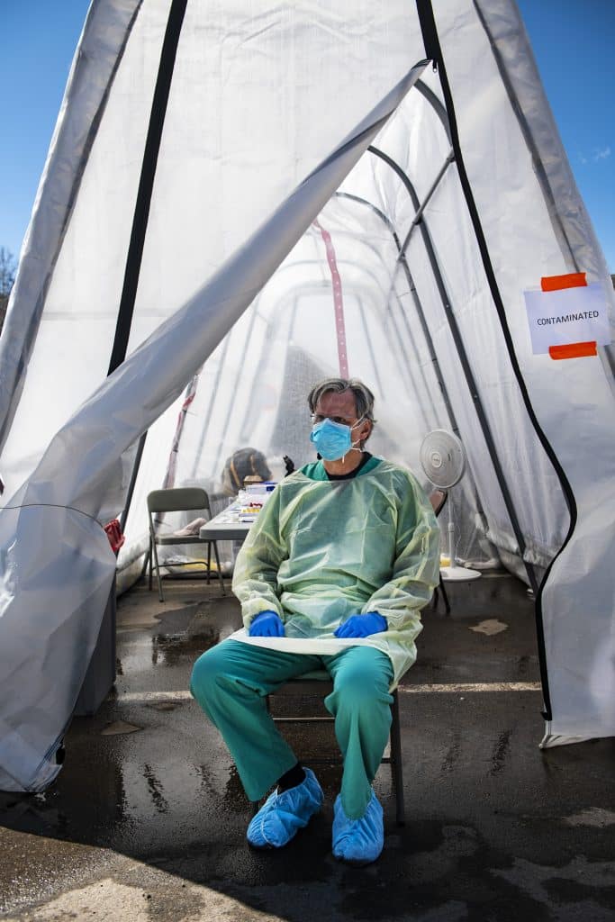Dr. Kelly Locke sits in the “contaminated” side of the respiratory tent outside of the Aspen Valley Hospital on Thursday, April 2, 2020. This side of the tent is used to test patients and the healthcare providers must be dressed in full PPE. “The big thing we’ve been happy about is that we haven’t been overwhelmed with a surge, which we believe is partly because people in the valley are staying inside,” said Dr. Locke. 