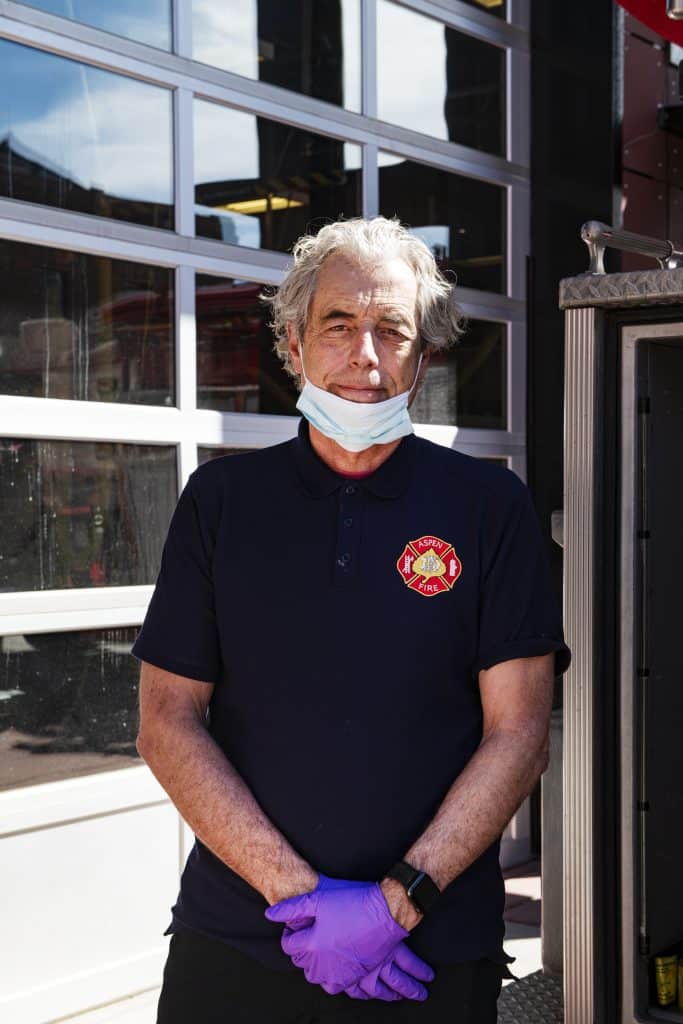 Aspen Volunteer Fire Department Chief Rick Balentine wears gloves and a mask while checking a fire engine outside of the fire house on Thursday, March 26, 2020. 