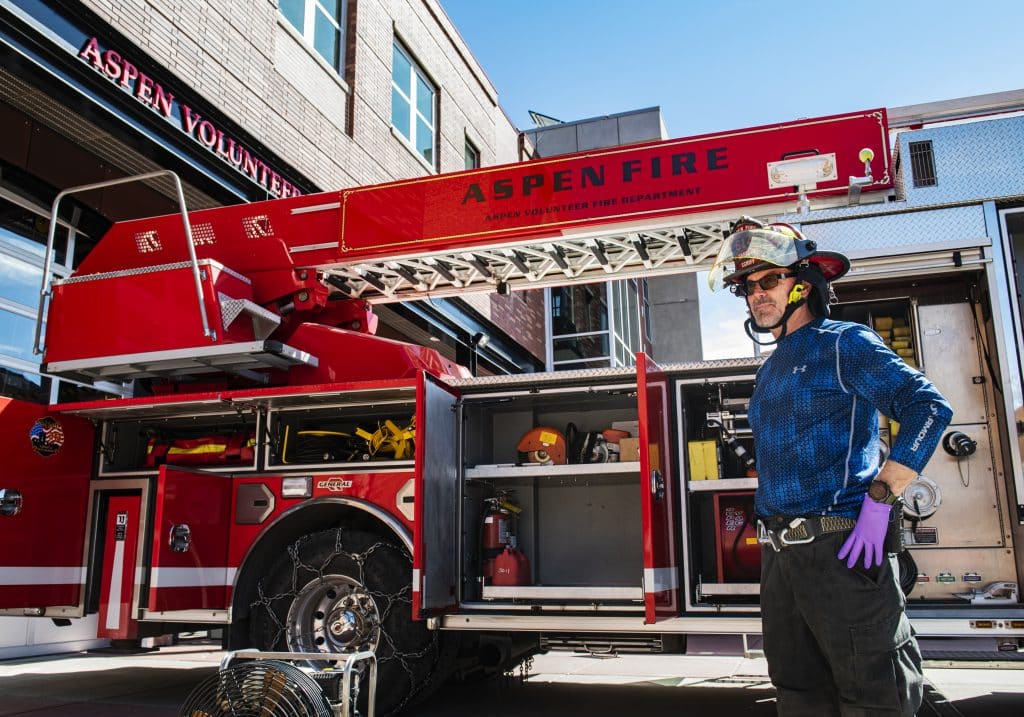 Aspen Volunteer Fire Department captain Sandy Schiff wears gloves while running truck checks outside of the fire house on Thursday, March 26, 2020. Schiff has been with the department for about six years. 