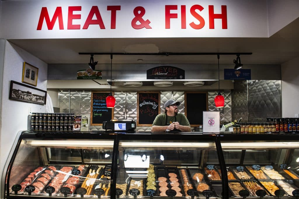 Matt “the butcher” Ellcessor stands behind the counter at Roxy’s Market on Friday, April 3, 2020. Ellcessor opened the butcher shop nearly four years ago and he said that there’s no shortage of meat in the store.