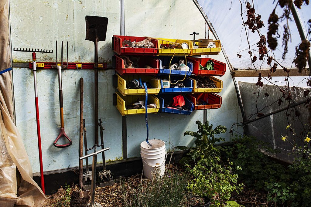 Farming tools are organized against the back wall of one o the greenhouses belonging to Wild Mountain Seeds in Carbondale on Thursday, April 2, 2020. (Kelsey Brunner/The Aspen Times)