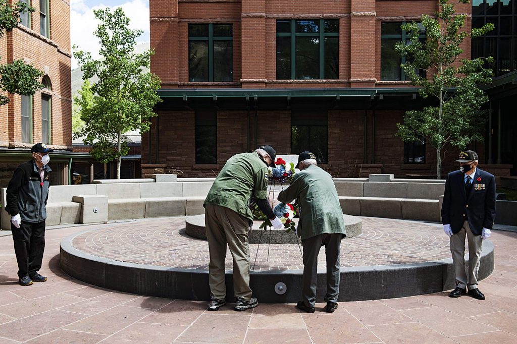 Honor Guard and Vietnam veterans Bob “Gunny” Perigo, center left, and Palmer Hood post the Memorial Day wreath at the Veterans Memorial while Dan Glidden, left, and Dick Merritt observe in Aspen on Monday, May 25, 2020. (Kelsey Brunner/The Aspen Times)