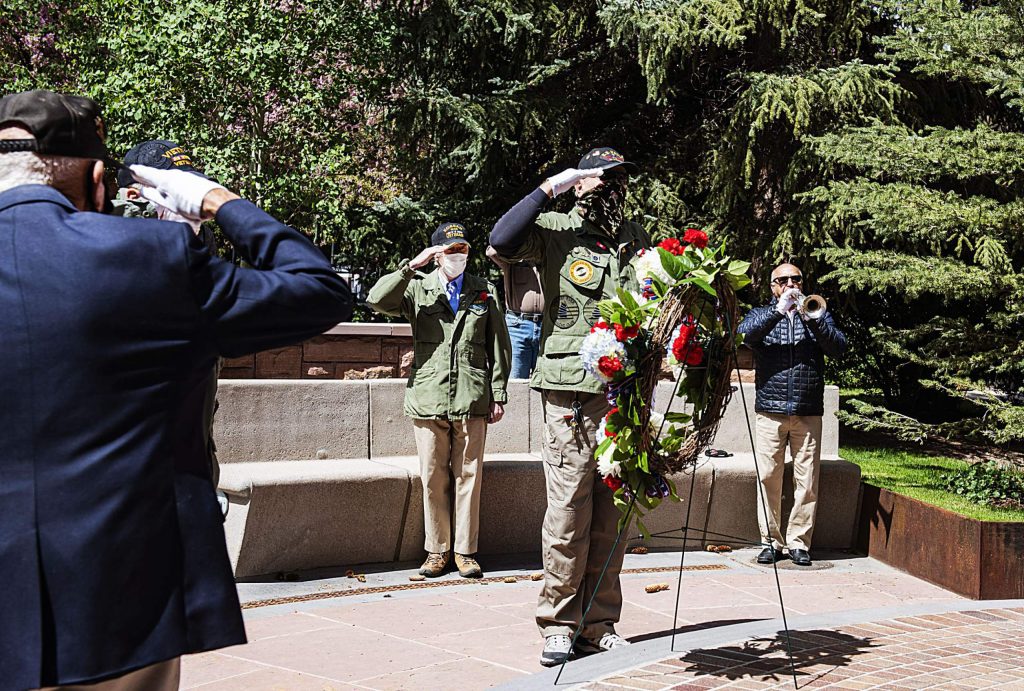 Taps is played as veterans salute the Memorial Day Wreath at the Veterans Memorial in Aspen on Monday, May 25, 2020. (Kelsey Brunner/The Aspen Times)