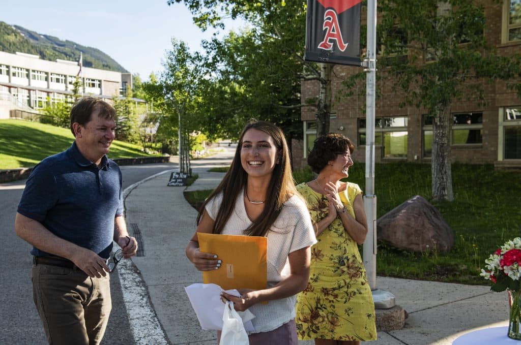 Kat Goralka, center, walks back to her car with her parents Mike and Caryn after receiving her scholarships and salutatorian honors during the scholarship drive-through event on Thursday, May 28, 2020. (Kelsey Brunner/The Aspen Times)