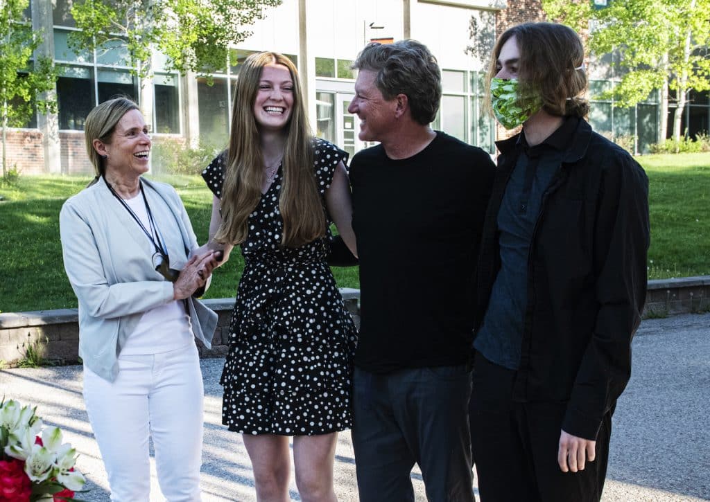 Aspen High School’s Maxine Mellin, center left, stands with her family as her scholarships are announced during the drive-through event at Aspen School District Campus on Thursday, May 28, 2020. (Kelsey Brunner/The Aspen Times)