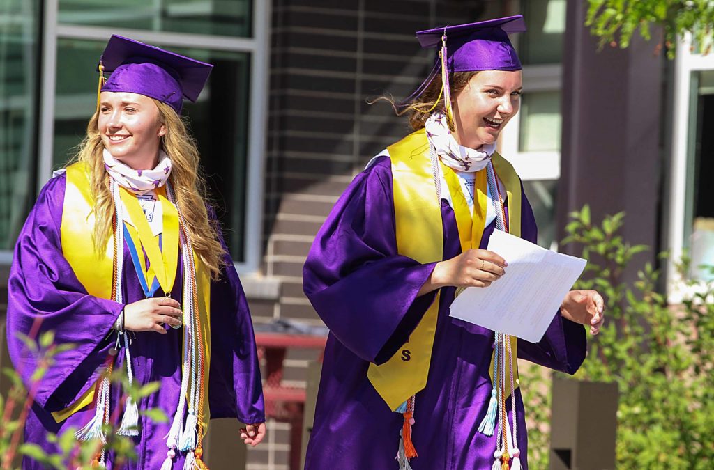 Anne Schrock and Sasha Brucker smile and laugh after giving their valedictorian speeches at the Basalt High School Class of 2020 graduation ceremony on May 30, 2020. (Maddie Vincent/The Aspen Times).