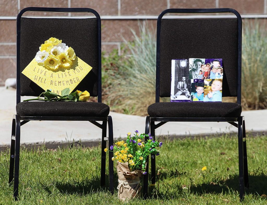 Graduation caps in memory of Anna Cunningham and Tyler Ribich sit on chairs near the stage of the Basalt High School Class of 2020 graduation ceremony on May 30, 2020. Both Cunningham and Ribich were chosen by their classmates for the school's Wall of Fame. (Maddie Vincent/The Aspen Times).