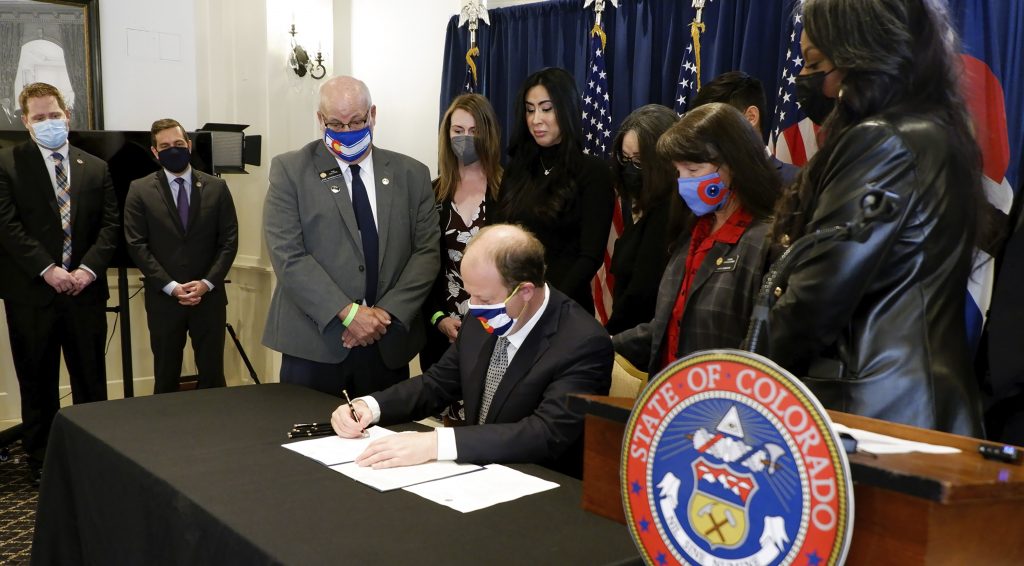 Colorado governor signs gun storage, lost weapons bills into law ...