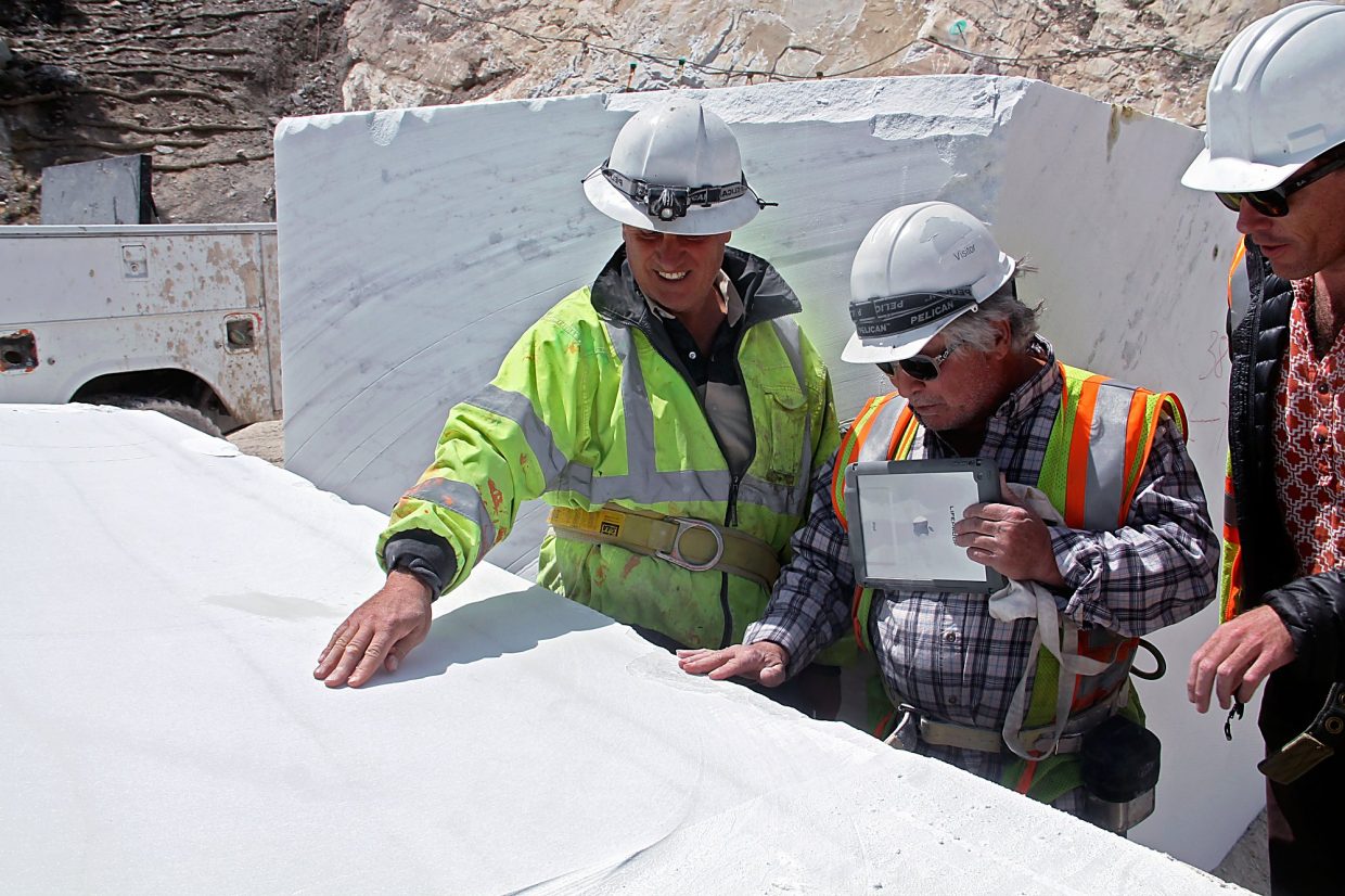 Stefano Mazzucchelli (left) shows off a piece of marble to local sculpture Greg Tonozzi.