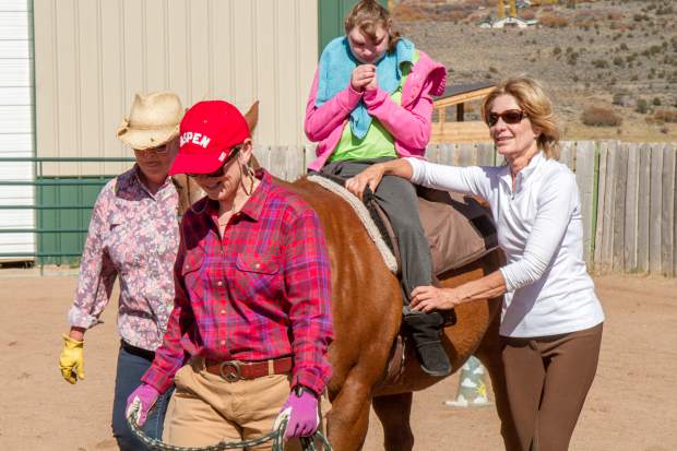 Amanda VanDeursen riding horse Freddy during her session with the WindWalkers Equine Assisted Learning and Therapy Center.