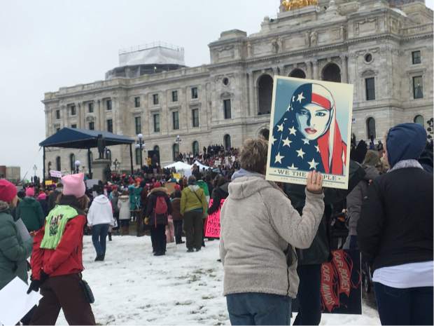 A protester holds sign at Minnesota Women's March in front of state Capitol in St. Paul, Minn., on Saturday, Jan. 21, 2017. The march was held in in conjunction with with similar events taking place around the nation following the inauguration of President Donald Trump. (AP Photo/Jeff Baenen)
