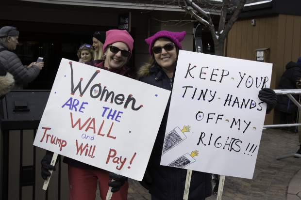 Helen Kasper and Val Fuller from Glenwood Springs proudly hold up their signs during the women's march in Aspen on Saturday.