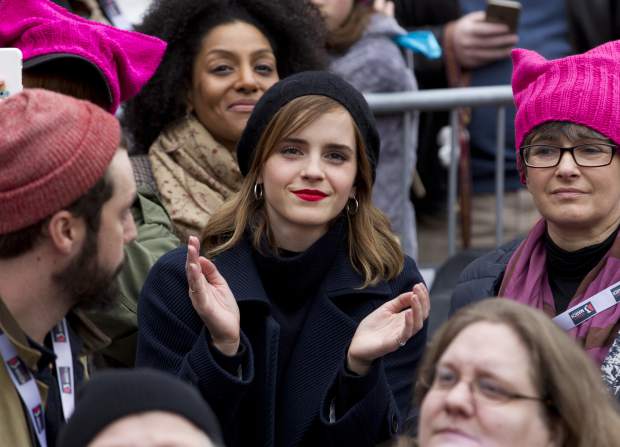 Actress Emma Watson sits in the crowd during the Women's March on Washington, Saturday, Jan. 21, 2017 in Washington. 