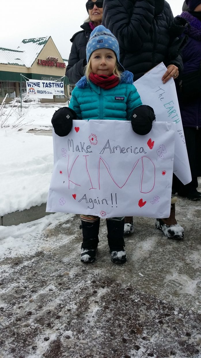 A young marcher's sign in Carbondale on Saturday urges kindness. 