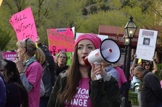A protester leads the crowd in chants outside the Hotel Colorado, where Sen. Cory Gardner held a private fundraising dinner Friday evening.