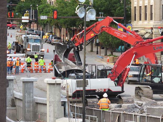 Equipment loads one of the estimated 174 truckloads of rubble from the old Grand Avenue bridge.