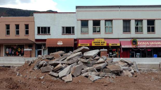 Chunks of the old Grand Avenue bridge deck await loading as workers took a lunch break Monday in downtown Glenwood Springs.