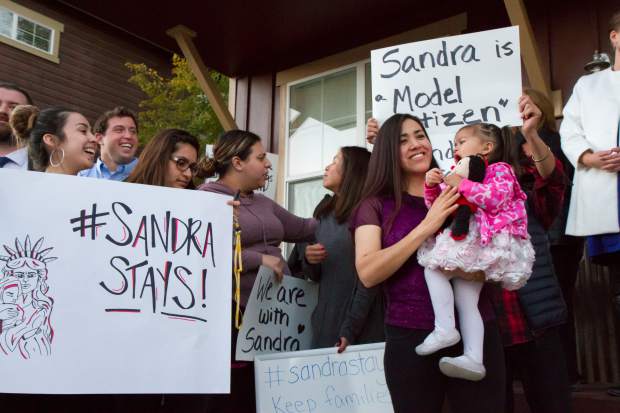 Sandra Lopez and her two-year-old daughter Areli stand with her supports during the press conference in Carbondale on Tuesday evening.