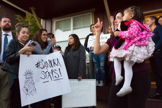 Sandra Lopez and her 2-year-old daughter Areli stand with her supporters during the press conference in Carbondale on Tuesday evening.