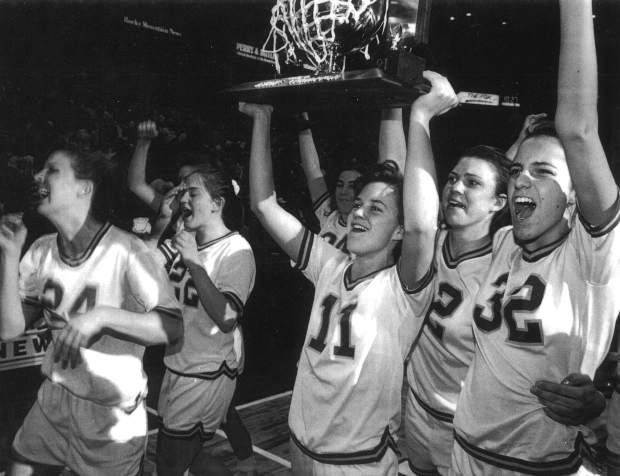 Tricia Bader, No. 11, hoists one of the three Colorado girls basketball championships she helped her Rams win from 1989-91.