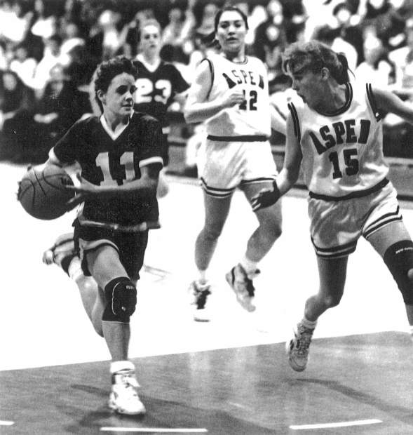 Tricia Bader dribbles past some Aspen defenders during her high school playing years.