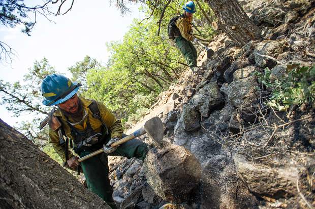 Oregon firefighters Markus Idroga, left, and Martin Sierra put out hot spots above the Wilds neighborhood in Basalt from the Lake Christine Fire on Sunday afternoon.