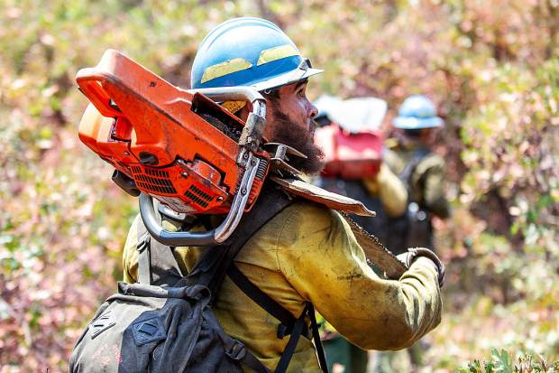 Oregon firefighter Markus Idroga walking back from the line on the Lake Christine Fire on Sunday afternoon.