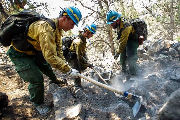 From left, firefighters Martin Sierra, Ismael Corona and Martin Sierra put out Lake Christine Fire hot spots above the Wilds neighborhood in Basalt on Sunday afternoon.