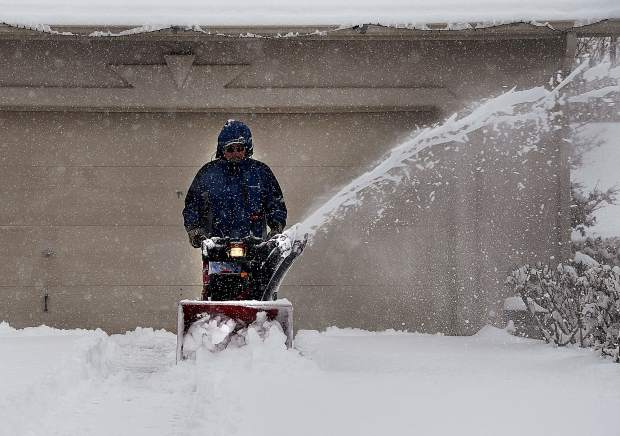 Butch Lontine of Silt helps out a neighbor by clearing her drive way Monday in Eagles View. “I don’t mind the cold, and I like helping out folk,” Lontine said.