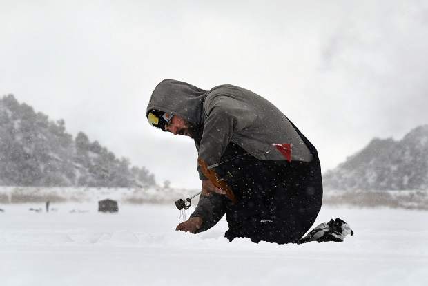 Travis Payne of Junction sets a line hoping to catch a fish or two Monday at Grass Valley Reservior.
