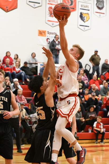 Glenwood Springs Demon Luke Gair jumps for the layup during Friday night's game against the Battle Mountain Huskies at Glenwood Springs High School.