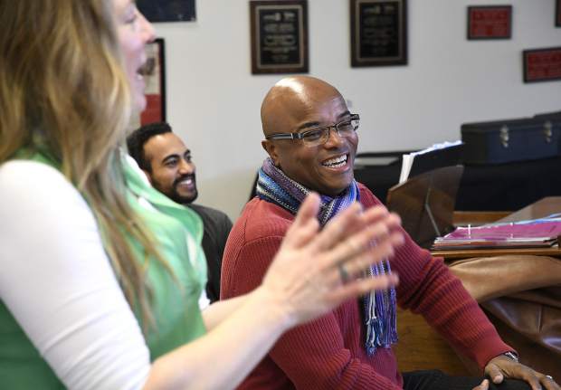 Shanti Gruber, Art Williams and Leon Williams share a laugh as they work with the concert choir Tuesday at Glenwood Springs High School.