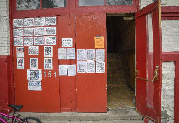 The front entry of the old school house in New Castle is covered in letters, including an eviction notice.