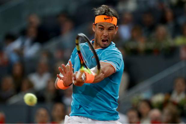 Rafael Nadal of Spain returns the ball to Stefanos Tsitsipas of Greece during the Madrid Open tennis men's semi-final match in Madrid, Spain, Saturday, May 11, 2019. (AP Photo/Bernat Armangue)