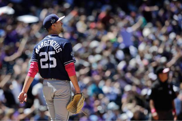 San Diego Padres starting pitcher Nick Margevicius (25) watches a home run by Colorado Rockies' Charlie Blackmon in the fourth inning of a baseball game in Denver, Sunday, May 12, 2019. (AP Photo/Joe Mahoney)