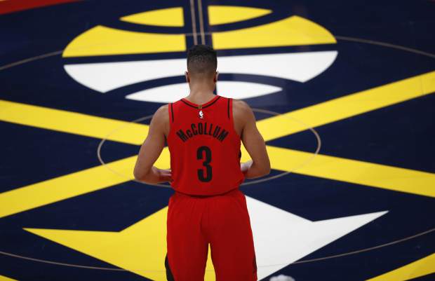 Portland Trail Blazers guard CJ McCollum stands at center court waiting for the start of the first half of Game 7 of an NBA basketball second-round playoff series against the Denver Nuggets Sunday, May 12, 2019, in Denver. (AP Photo/David Zalubowski)