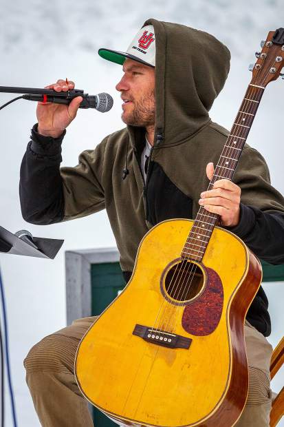 Ski racer and musician Mark Engel dedicates a song to Sam Coffey at a memorial service Monday held on Richmond Ridge.