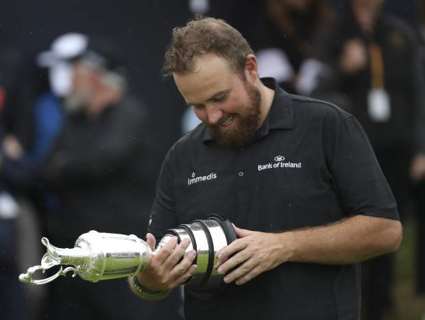 Ireland's Shane Lowry looks down at the Claret Jug trophy on the18th geen after winning the British Open Golf Championships at Royal Portrush in Northern Ireland, Sunday, July 21, 2019.(AP Photo/Peter Morrison)