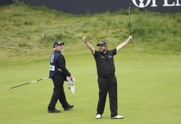 Ireland's Shane Lowry lifts his club to celebrate as he wins the British Open Golf Championships at Royal Portrush in Northern Ireland, Sunday, July 21, 2019.(AP Photo/Peter Morrison)