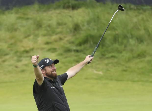 Ireland's Shane Lowry lifts his club to celebrate as he wins the British Open Golf Championships at Royal Portrush in Northern Ireland, Sunday, July 21, 2019.(AP Photo/Peter Morrison)
