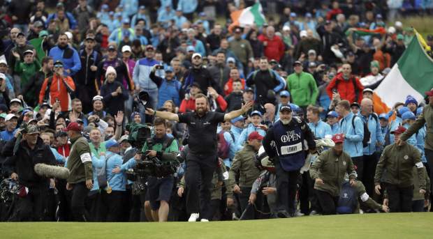 Ireland's Shane Lowry walks arms outstretched on the 18th green on his way to winning the British Open Golf Championships at Royal Portrush in Northern Ireland, Sunday, July 21, 2019.(AP Photo/Matt Dunham)