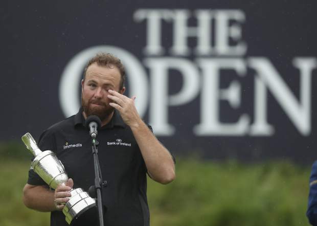 Ireland's Shane Lowry wipes away a tear as he makes a speech holding the Claret Jug trophy after winning the British Open Golf Championships at Royal Portrush in Northern Ireland, Sunday, July 21, 2019.(AP Photo/Jon Super)