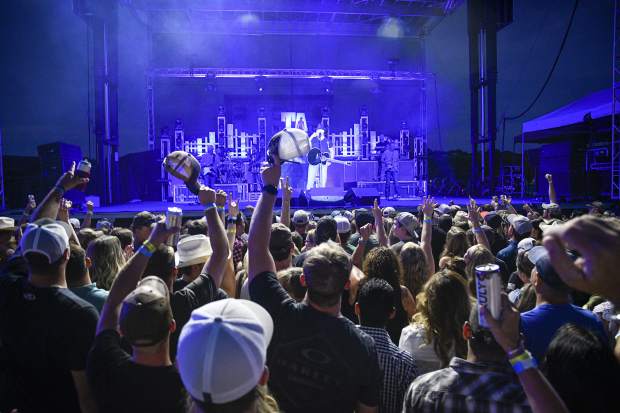 The crowd tips its hats and raise a toast with Trace Adkins as he peforms Friday night in Rifle.