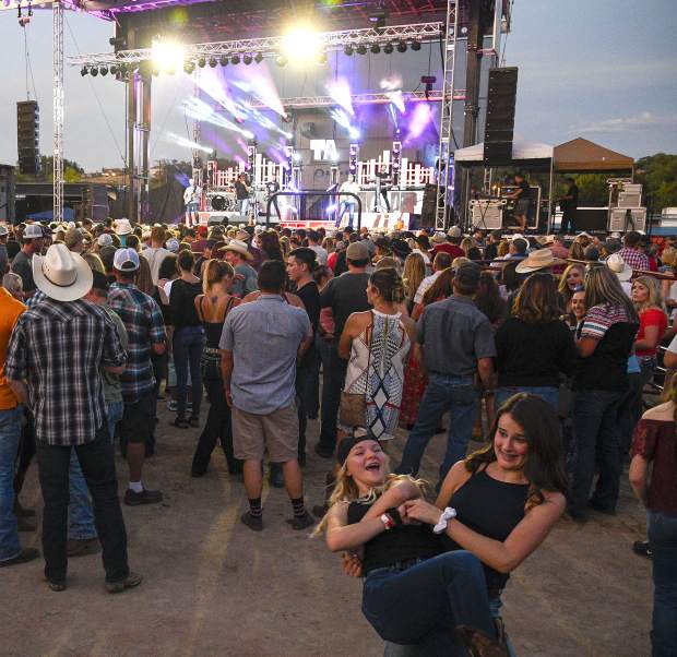 Garfield County Fair concert headliner Trace Adkins has the crowd dancing in the dirt during Friday night's concert.