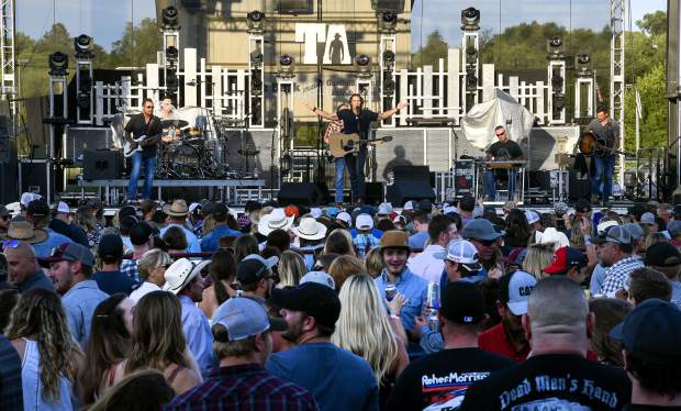 With the sun setting on the Garfield County Fairgrounds, a sea of people listen to Joe Nichols as he opens the Friday night concert.