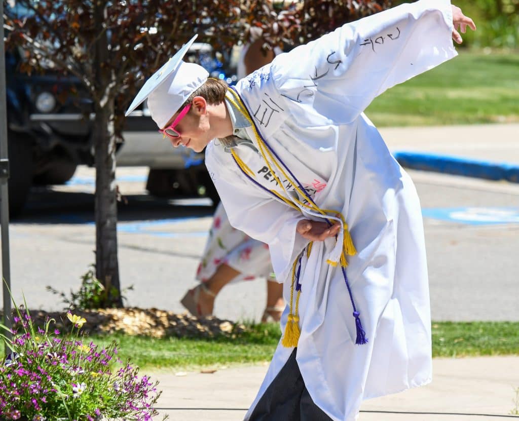 A 2020 Yampah Mountain High School graduate bows for the crowd at the drive-in graduation ceremony on Friday morning.