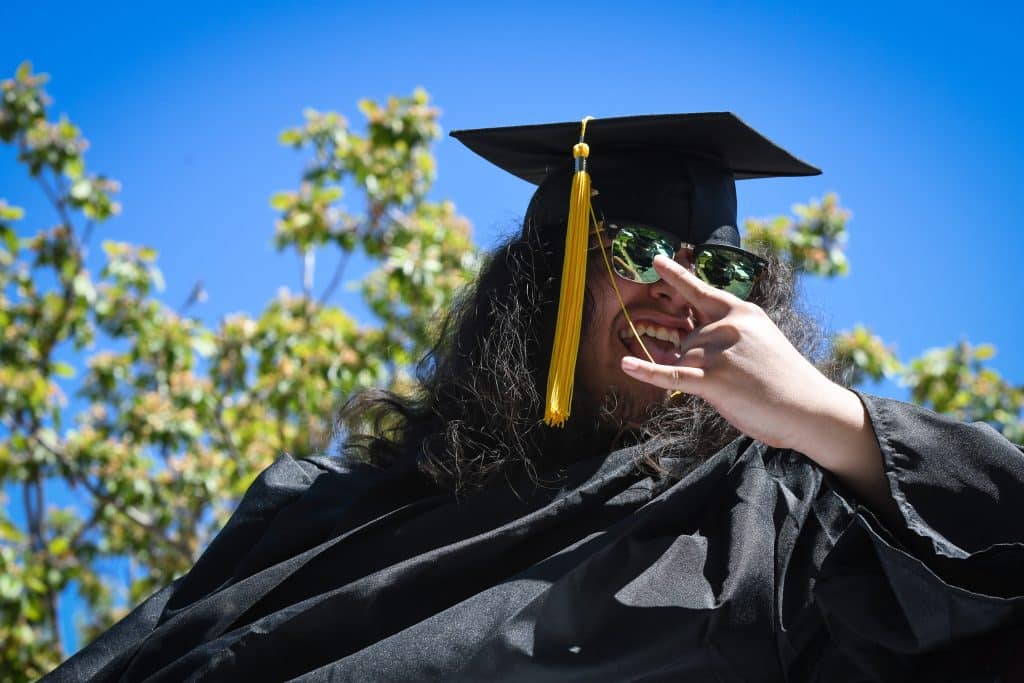 A Yampah Mountain high School graduate reacts to supporters during the drive-in graduation ceremony on Friday morning.