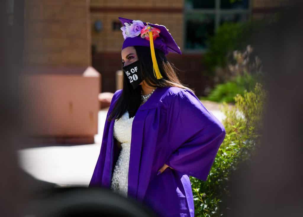 A Yampah Mountain High School graduate listens in as her advisor says a few words about her at the drive-in graduation ceremony on Friday morning.