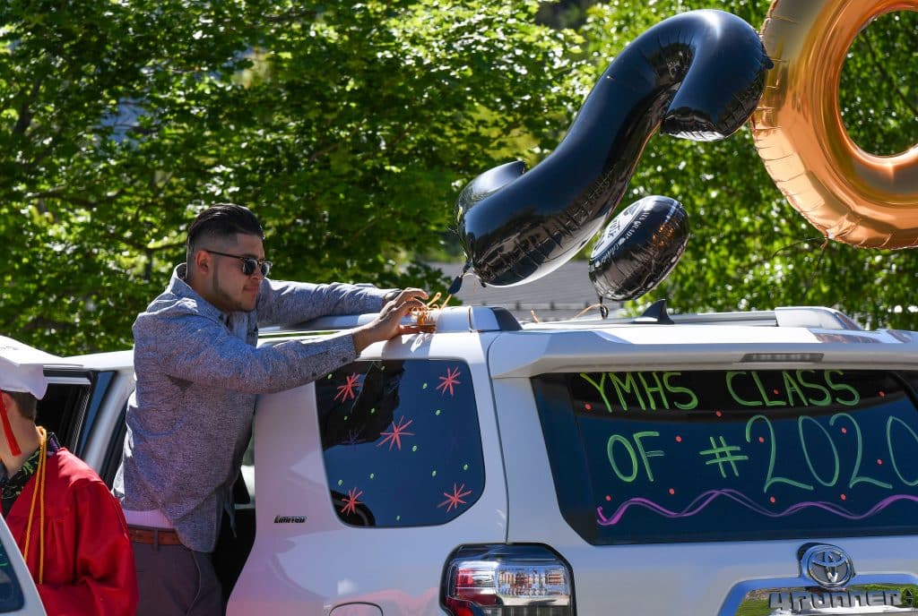 People decorate their cars before the start of the drive-in graduation ceremony for the Yampah Mountain High School class of 2020 on Friday morning.